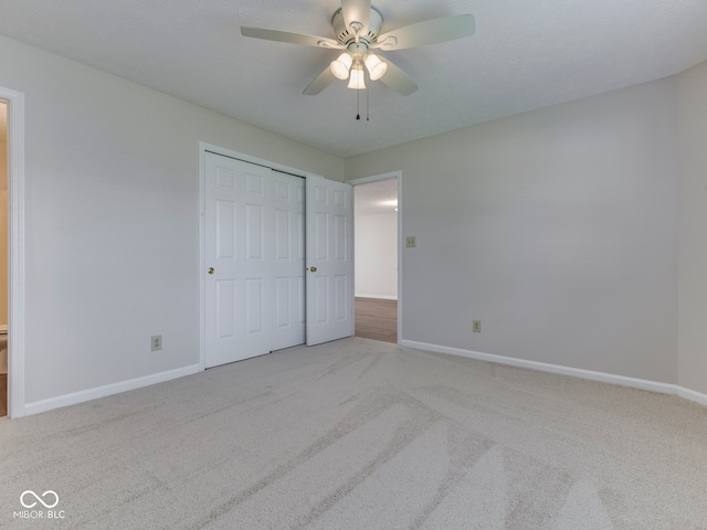 824 Ashton Park Dr, Greenwood, IN 46143 - unfurnished bedroom featuring carpet floors, baseboards, a closet, and a ceiling fan