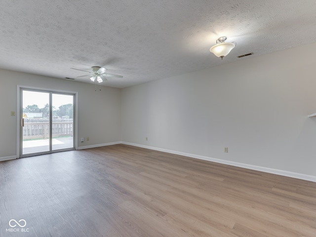 824 Ashton Park Dr, Greenwood, IN 46143 - spare room with ceiling fan, light wood-style flooring, a textured ceiling, and baseboards