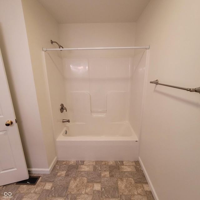 1306 W Daniel Dr, Greensburg, IN 47240 - full bathroom featuring baseboards, stone finish flooring, and tub / shower combination