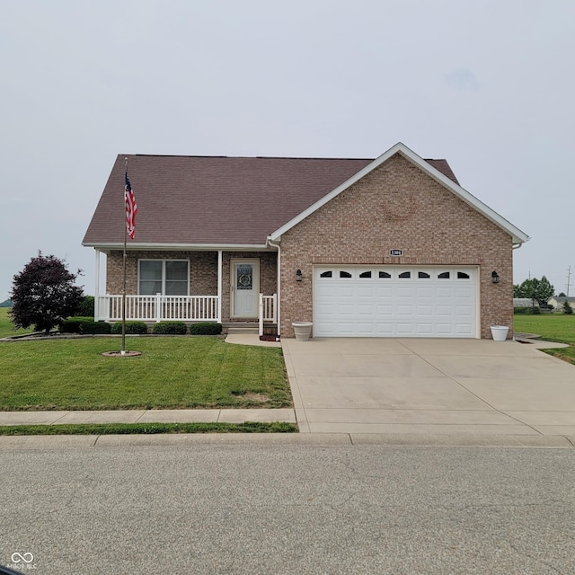 1306 W Daniel Dr, Greensburg, IN 47240 - view of front of house featuring concrete driveway, a garage, brick siding, a front lawn, and covered porch