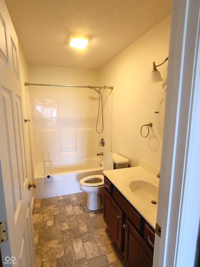 1306 W Daniel Dr, Greensburg, IN 47240 - bathroom featuring vanity, shower / tub combination, toilet, and stone finish flooring