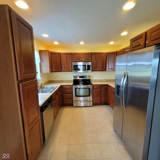 1306 W Daniel Dr, Greensburg, IN 47240 - kitchen with stainless steel appliances, a sink, light countertops, recessed lighting, and light tile patterned flooring