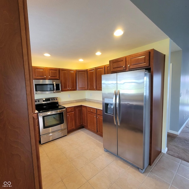 1306 W Daniel Dr, Greensburg, IN 47240 - kitchen featuring stainless steel appliances, light countertops, light tile patterned floors, recessed lighting, and baseboards