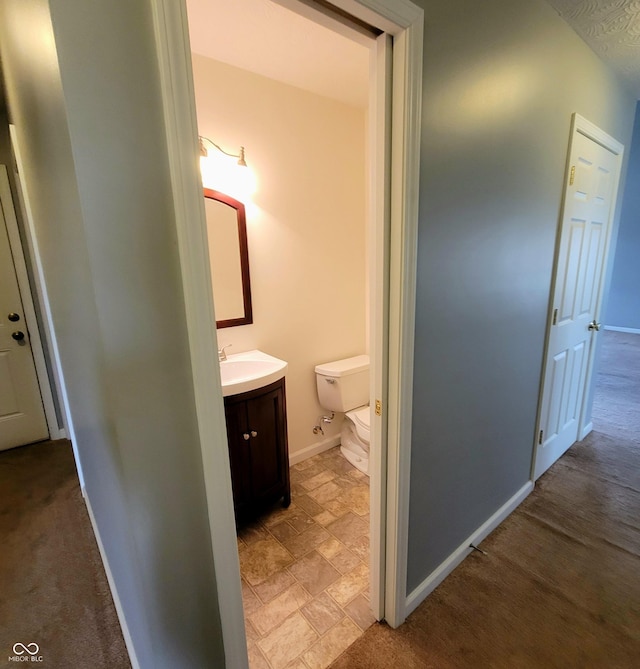 1306 W Daniel Dr, Greensburg, IN 47240 - half bath featuring vanity, baseboards, and toilet
