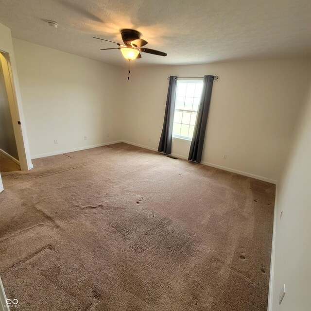 1306 W Daniel Dr, Greensburg, IN 47240 - unfurnished room featuring ceiling fan, carpet, and baseboards