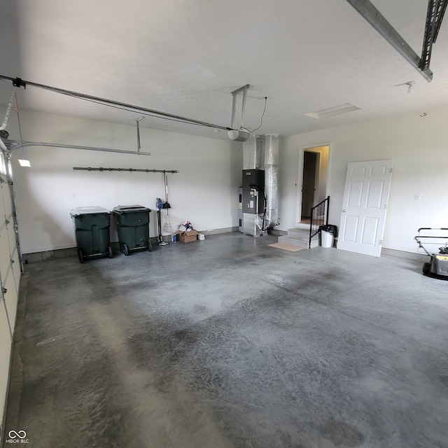 1306 W Daniel Dr, Greensburg, IN 47240 - garage featuring baseboards, heating unit, and a garage door opener