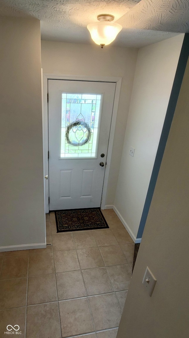 1306 W Daniel Dr, Greensburg, IN 47240 - entrance foyer featuring light tile patterned floors, baseboards, and a textured ceiling