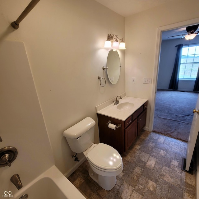 1306 W Daniel Dr, Greensburg, IN 47240 - full bathroom with stone finish floors, vanity, toilet, baseboards, and shower / tub combination