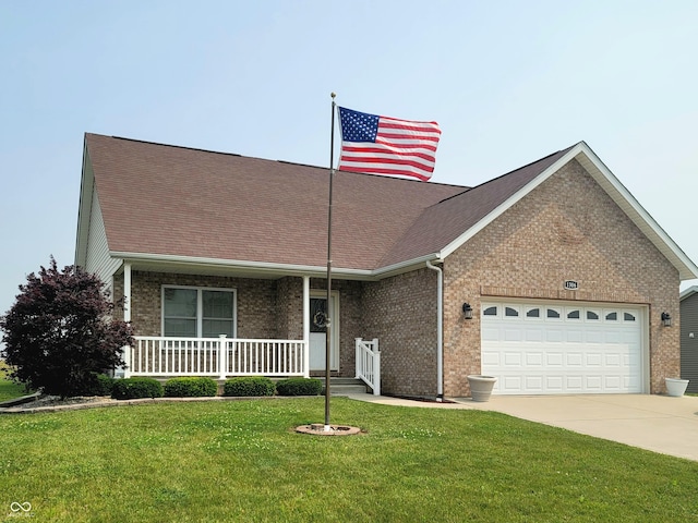 1306 W Daniel Dr, Greensburg, IN 47240 - view of front of house with an attached garage, concrete driveway, brick siding, covered porch, and a front lawn
