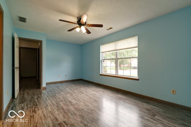 12157 Longstraw Dr, Indianapolis, IN 46236 - unfurnished bedroom with wood finished floors, a textured ceiling, baseboards, and ceiling fan