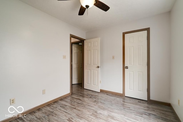 12157 Longstraw Dr, Indianapolis, IN 46236 - unfurnished bedroom with wood finished floors, baseboards, and a ceiling fan