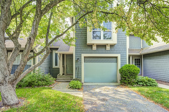 7507 Choate Ct, Indianapolis, IN 46254 - view of front facade with roof with shingles, a garage, and driveway