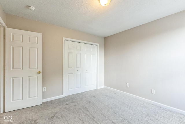 9692 Centennial Ct, Avon, IN 46123 - unfurnished bedroom with carpet flooring, a closet, baseboards, and a textured ceiling