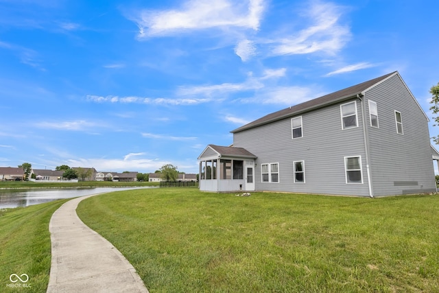 9692 Centennial Ct, Avon, IN 46123 - back of property featuring a sunroom, a water view, and a lawn