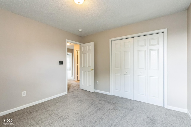 9692 Centennial Ct, Avon, IN 46123 - unfurnished bedroom featuring carpet floors, baseboards, a closet, and a textured ceiling
