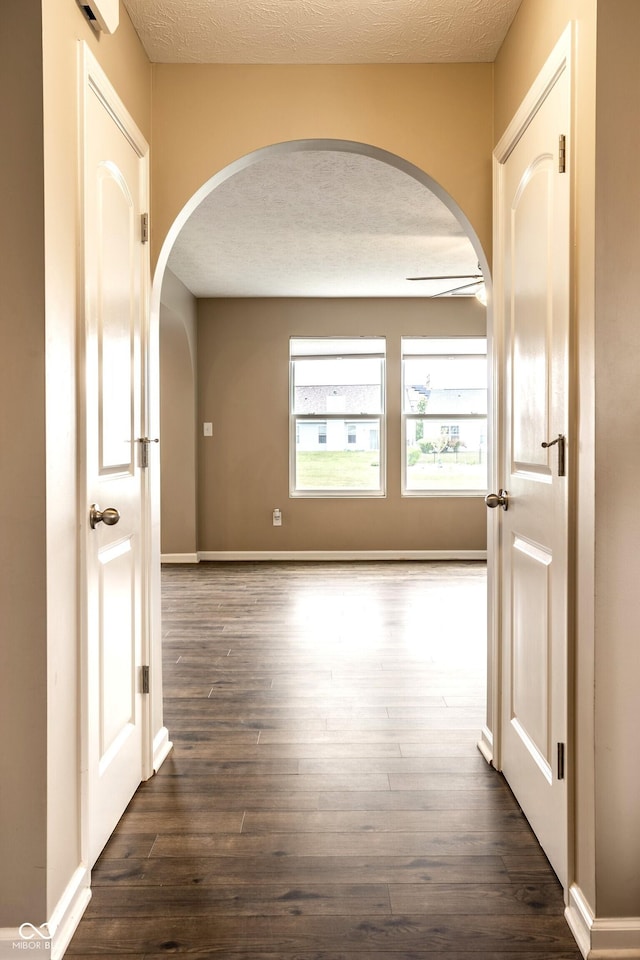 6114 Pebblebrooke Rd, Whitestown, IN 46075 - hallway featuring arched walkways and dark wood-type flooring