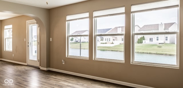 6114 Pebblebrooke Rd, Whitestown, IN 46075 - doorway with arched walkways, baseboards, and wood finished floors