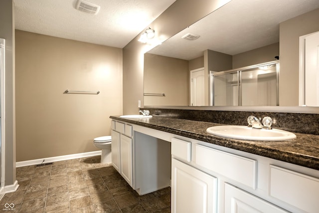 6114 Pebblebrooke Rd, Whitestown, IN 46075 - full bathroom featuring double vanity, a shower stall, baseboards, toilet, and a textured ceiling
