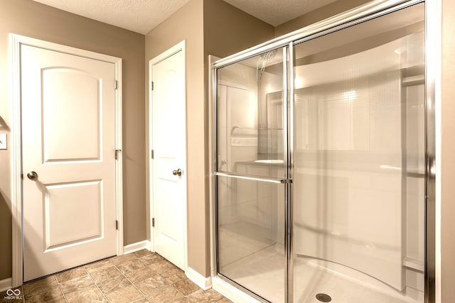 6114 Pebblebrooke Rd, Whitestown, IN 46075 - full bathroom with a textured ceiling, a shower stall, and baseboards