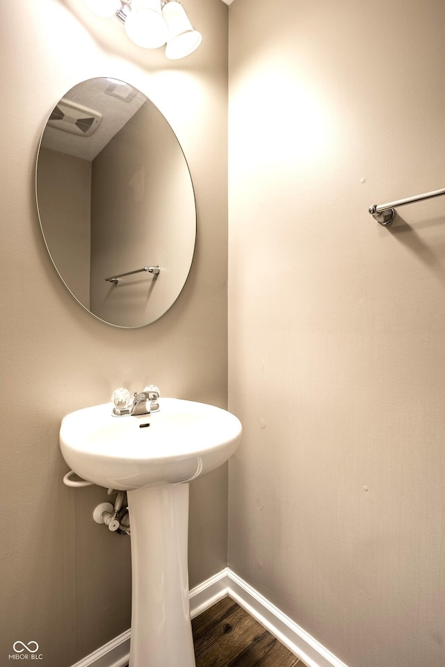 6114 Pebblebrooke Rd, Whitestown, IN 46075 - bathroom with baseboards, wood finished floors, and a sink