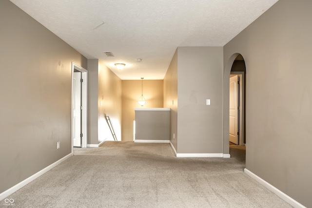 6114 Pebblebrooke Rd, Whitestown, IN 46075 - carpeted empty room with arched walkways, baseboards, and a textured ceiling