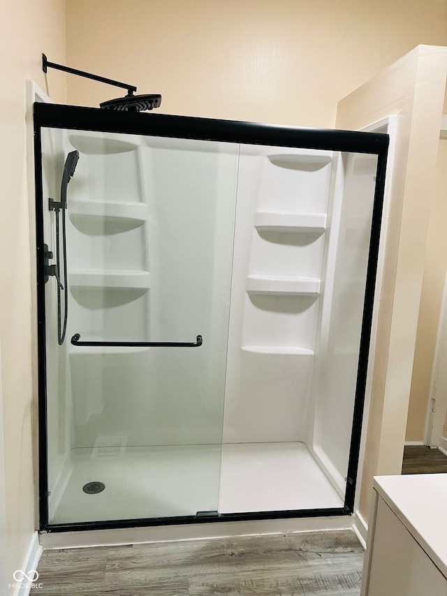 547 N Livingston Ave, Indianapolis, IN 46222 - full bath featuring a shower stall, wood finished floors, and vanity