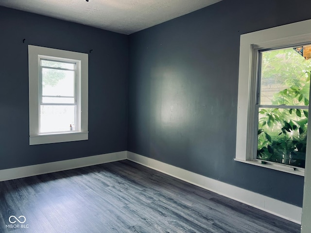 547 N Livingston Ave, Indianapolis, IN 46222 - spare room featuring dark wood finished floors and baseboards