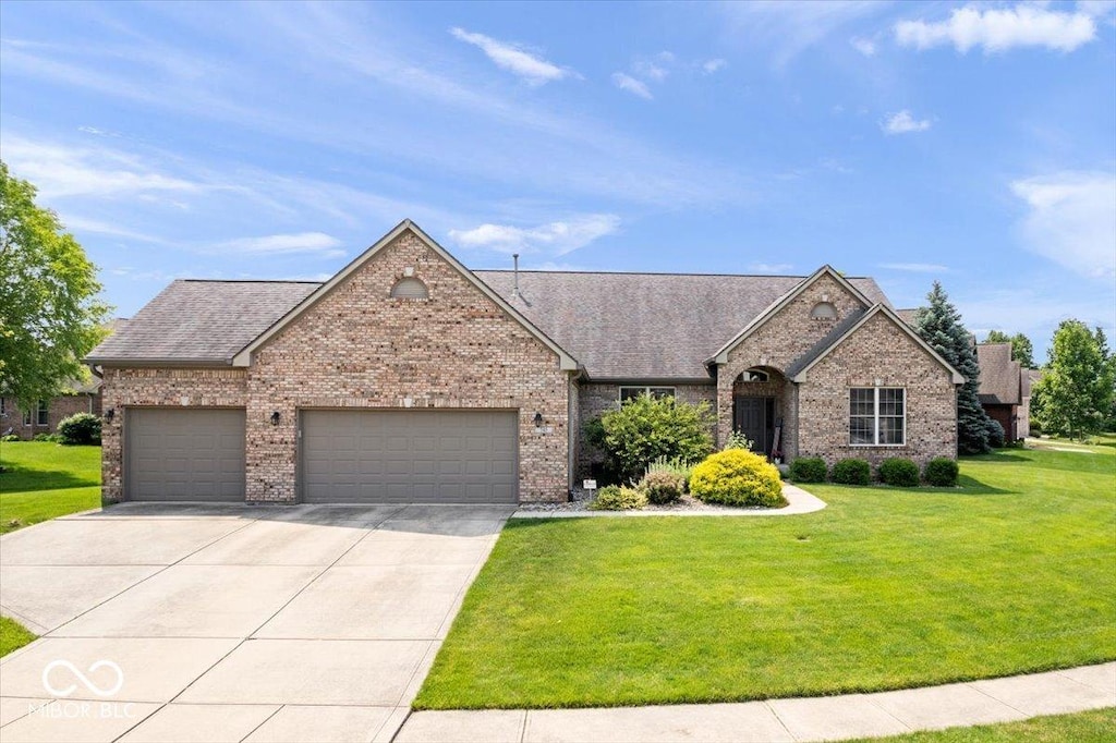 745 Ridge Gate Dr, Brownsburg, IN 46112 - view of front of home featuring a garage, brick siding, driveway, a front lawn, and roof with shingles