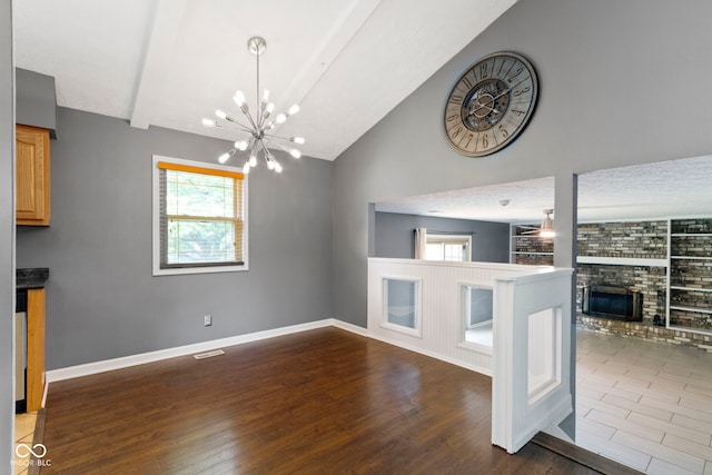 4718 Dancer Dr, Indianapolis, IN 46237 - unfurnished dining area featuring a fireplace, healthy amount of natural light, dark wood finished floors, built in shelves, and high vaulted ceiling