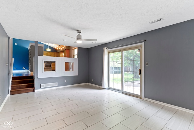 4718 Dancer Dr, Indianapolis, IN 46237 - unfurnished living room with ceiling fan, stairs, and a textured ceiling