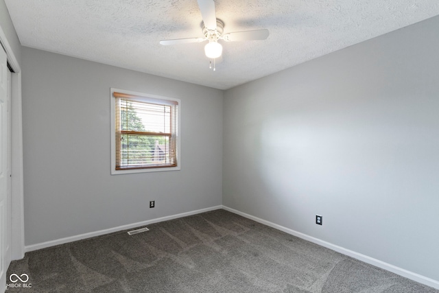 4718 Dancer Dr, Indianapolis, IN 46237 - unfurnished bedroom with dark carpet, a closet, a textured ceiling, and a ceiling fan