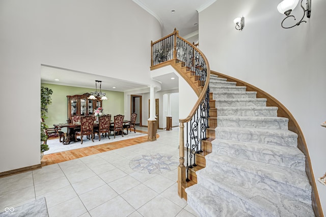 4181 Whitetail Woods Dr, Bargersville, IN 46106 - stairway featuring tile patterned flooring, crown molding, a towering ceiling, baseboards, and decorative columns
