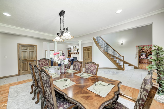 4181 Whitetail Woods Dr, Bargersville, IN 46106 - dining area with light tile patterned flooring, ornate columns, ornamental molding, a chandelier, and stairs