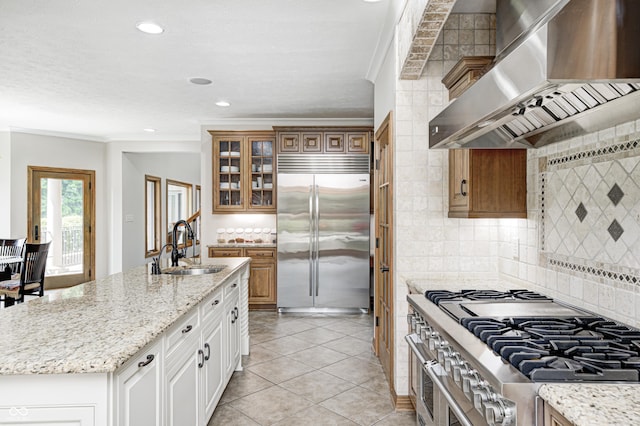 4181 Whitetail Woods Dr, Bargersville, IN 46106 - kitchen with exhaust hood, high end appliances, a sink, backsplash, and glass insert cabinets
