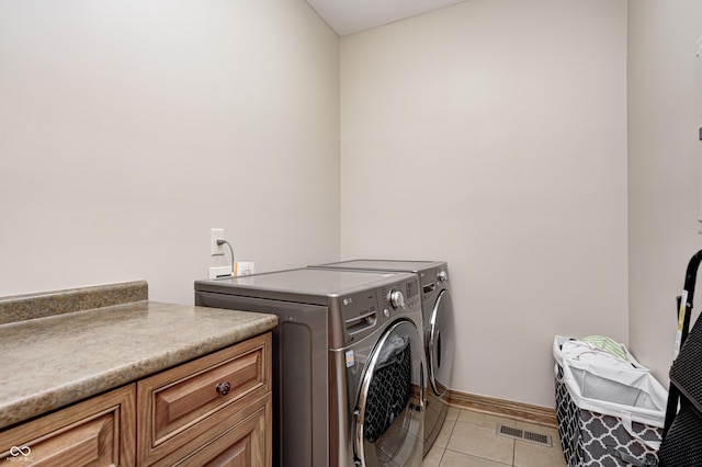 4181 Whitetail Woods Dr, Bargersville, IN 46106 - laundry area featuring washer and dryer, light tile patterned floors, baseboards, and cabinet space