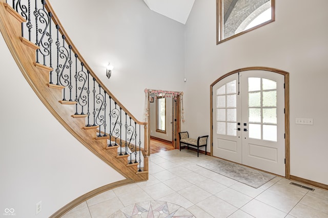 4181 Whitetail Woods Dr, Bargersville, IN 46106 - tiled foyer featuring high vaulted ceiling, french doors, arched walkways, stairs, and baseboards