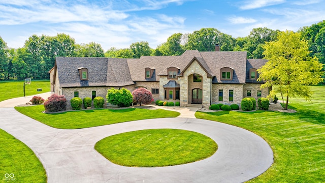 4181 Whitetail Woods Dr, Bargersville, IN 46106 - french country style house with stone siding, curved driveway, a front lawn, and a shingled roof