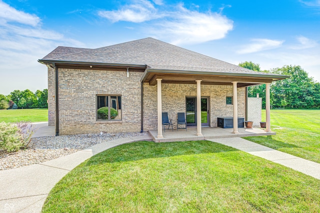 4181 Whitetail Woods Dr, Bargersville, IN 46106 - back of property featuring roof with shingles, a yard, a patio area, and brick siding