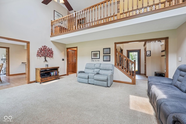 6983 White Oak Dr, Avon, IN 46123 - carpeted living room with baseboards, a high ceiling, ceiling fan, and stairway