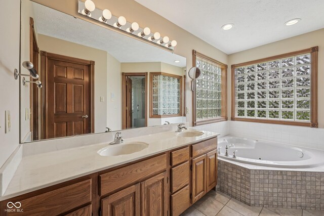 6983 White Oak Dr, Avon, IN 46123 - full bath featuring double vanity, a tub with jets, tile patterned flooring, and recessed lighting
