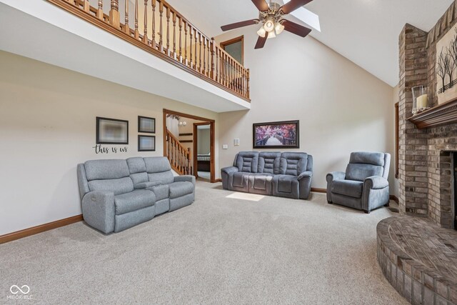 6983 White Oak Dr, Avon, IN 46123 - carpeted living room featuring high vaulted ceiling, stairway, a fireplace, ceiling fan, and baseboards