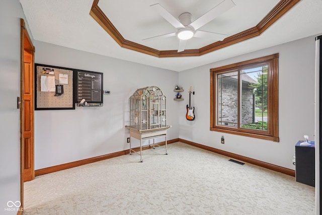 6983 White Oak Dr, Avon, IN 46123 - spare room with a tray ceiling, carpet floors, ceiling fan, baseboards, and ornamental molding