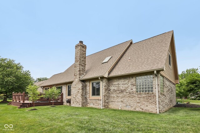 6983 White Oak Dr, Avon, IN 46123 - back of property featuring brick siding, a deck, a chimney, a lawn, and roof with shingles