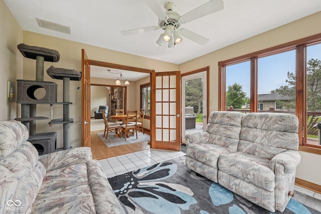 6983 White Oak Dr, Avon, IN 46123 - tiled living area with healthy amount of natural light, ceiling fan, and baseboards