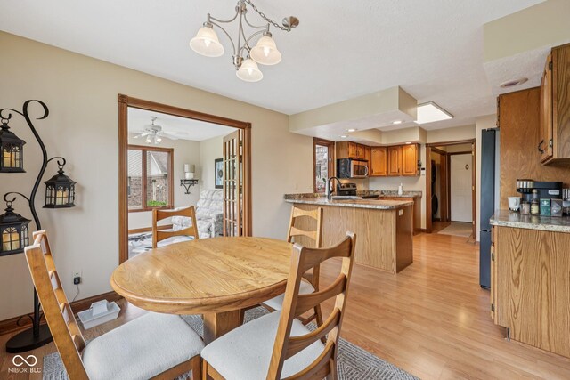 6983 White Oak Dr, Avon, IN 46123 - dining room with light wood-style floors, a chandelier, and baseboards