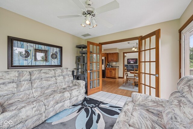 6983 White Oak Dr, Avon, IN 46123 - living area with french doors, ceiling fan, and light wood-type flooring