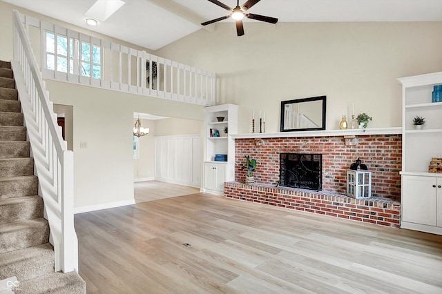 7430 Railway Ct, Indianapolis, IN 46256 - unfurnished living room featuring light wood-style floors, stairway, ceiling fan, high vaulted ceiling, and a fireplace