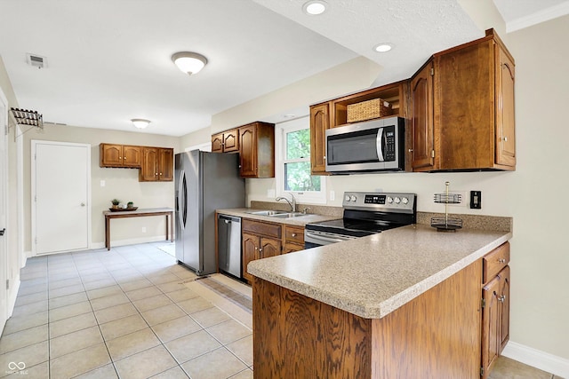 7430 Railway Ct, Indianapolis, IN 46256 - kitchen featuring stainless steel appliances, a sink, a peninsula, brown cabinetry, and recessed lighting