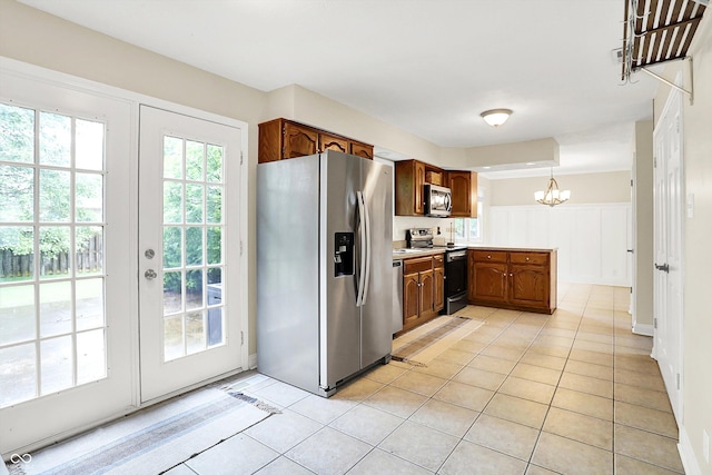 7430 Railway Ct, Indianapolis, IN 46256 - kitchen with stainless steel appliances, a chandelier, light tile patterned floors, and french doors
