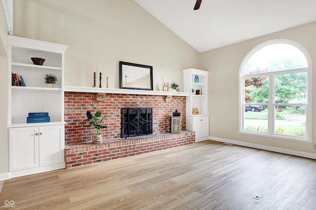 7430 Railway Ct, Indianapolis, IN 46256 - unfurnished living room featuring light wood-type flooring, a brick fireplace, healthy amount of natural light, baseboards, and high vaulted ceiling